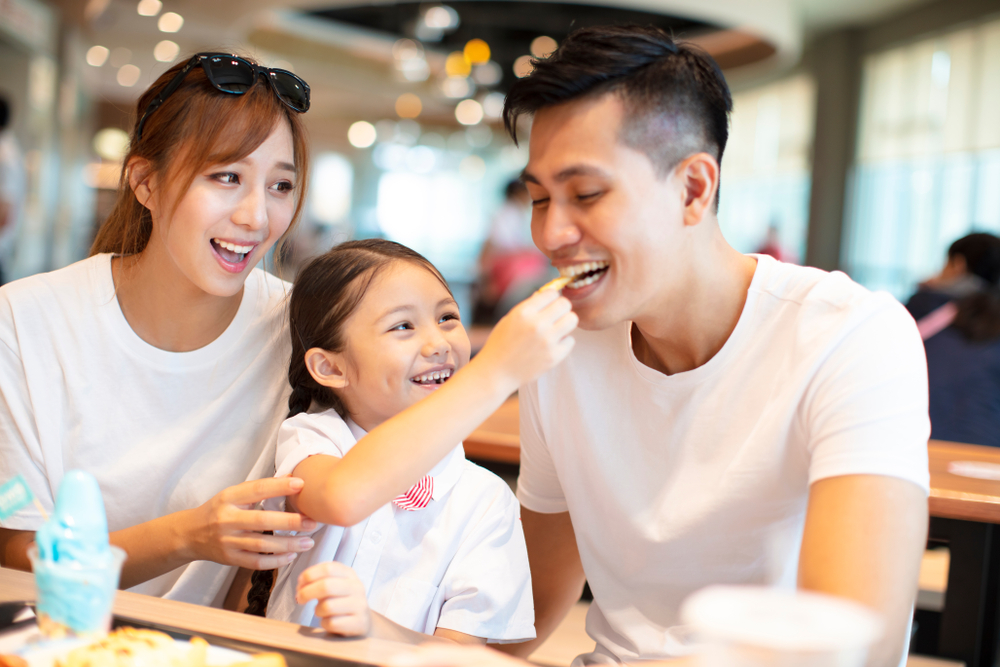 A young family eating out