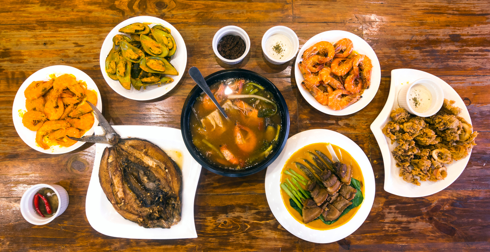 Various Filipino dishes on a wooden table